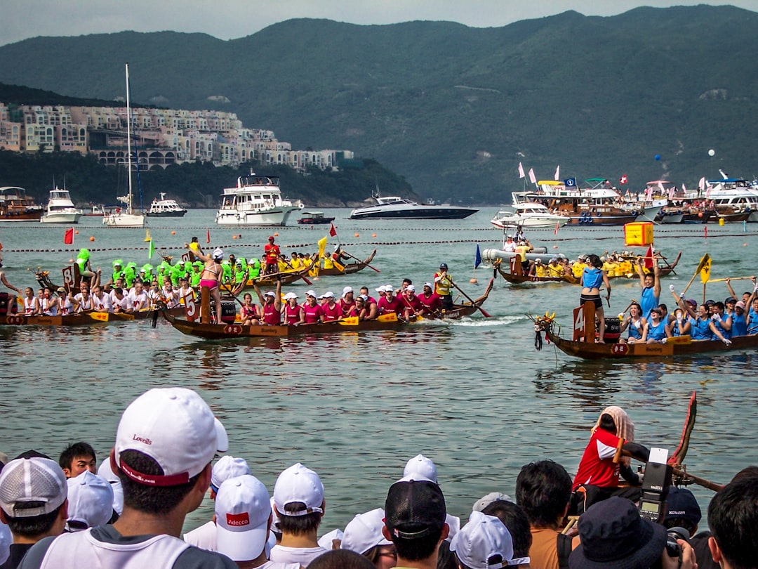 A team of paddlers competing in June festivals Singapore dragon boat races at Bedok Reservoir, drums beating .