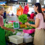 Elderly hawker serves at a traditional Singapore hawker centre,representing one of the city's most enduring Singapore rituals