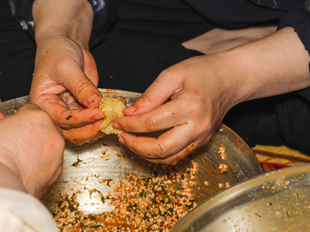A woman carefully wrapping zongzi rice dumplings at a Dragon Boat Festival workshop in Singapore