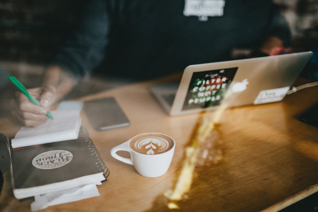 A diaspora entrepreneur works at a centre cafe, illustrating the hustle of diaspora entrepreneurs building a businesses