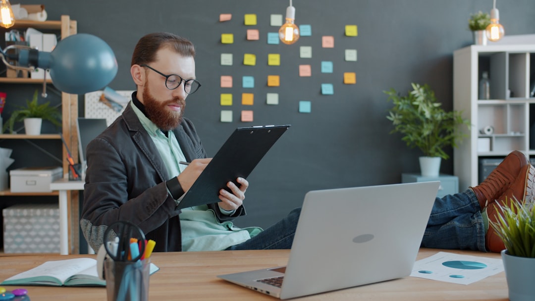 A first-time founder reviewing Singapore grants on a laptop in a Singapore co-working office