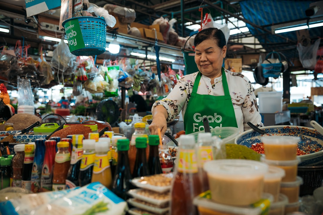 A hawker stallholder in Singapore serves Hainanese chicken rice, one of the most beloved National Day dishes on the island.