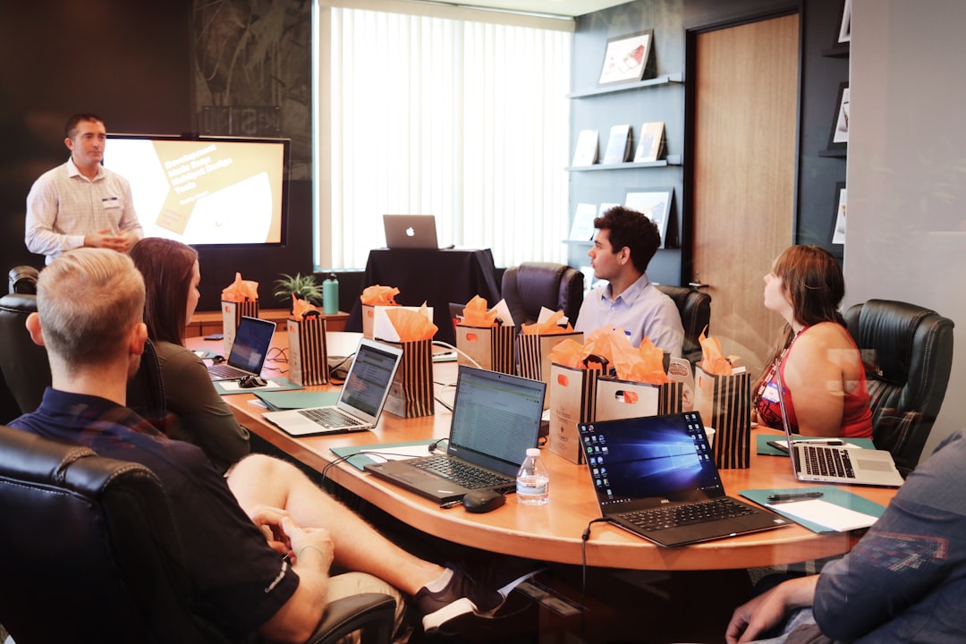 A Singapore startup founder reviews equity crowdfunding platform options on a laptop during a funding meeting