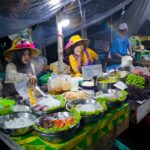 A chef preparing traditional hawker dishes at a Singapore food festival stall, showcasing local culinary heritage