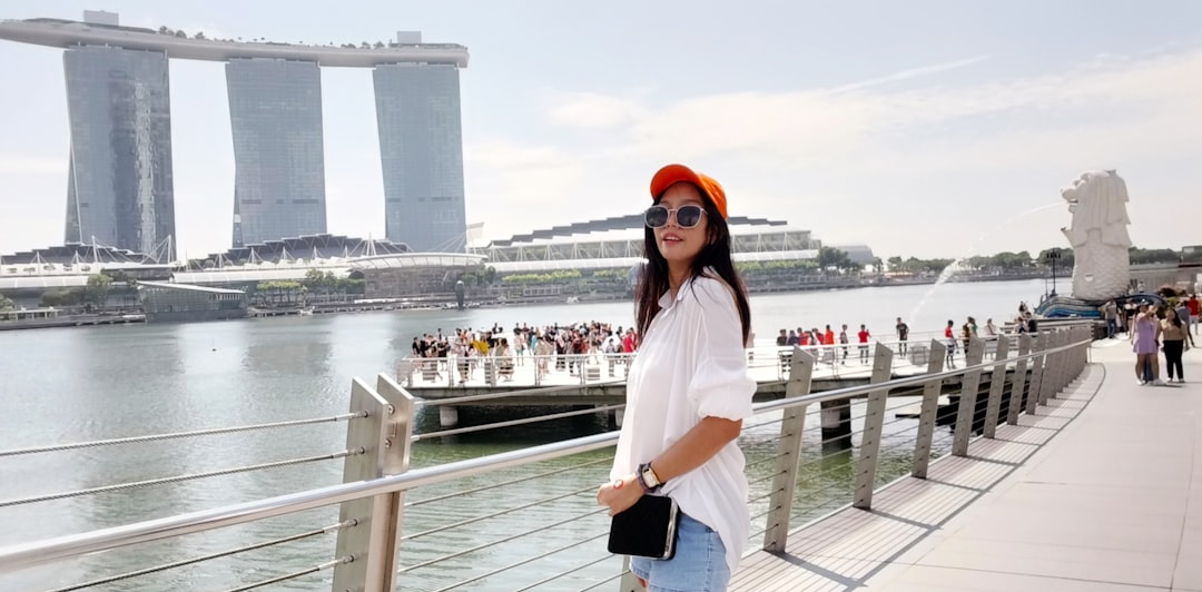 A traveller carrying a backpack boards a ferry at a Singapore terminal, ready for one of many weekend escapes from Singapore