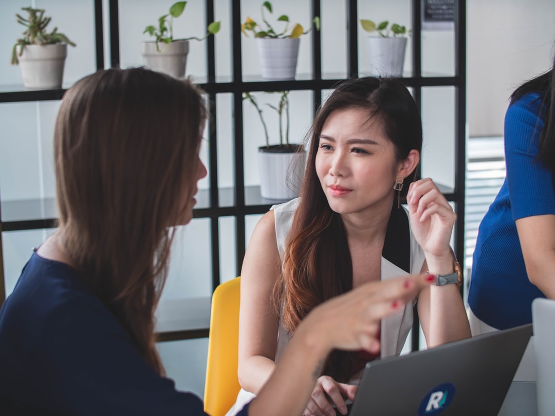A professional woman in a Singapore office reviews documents during the city's August hiring surge