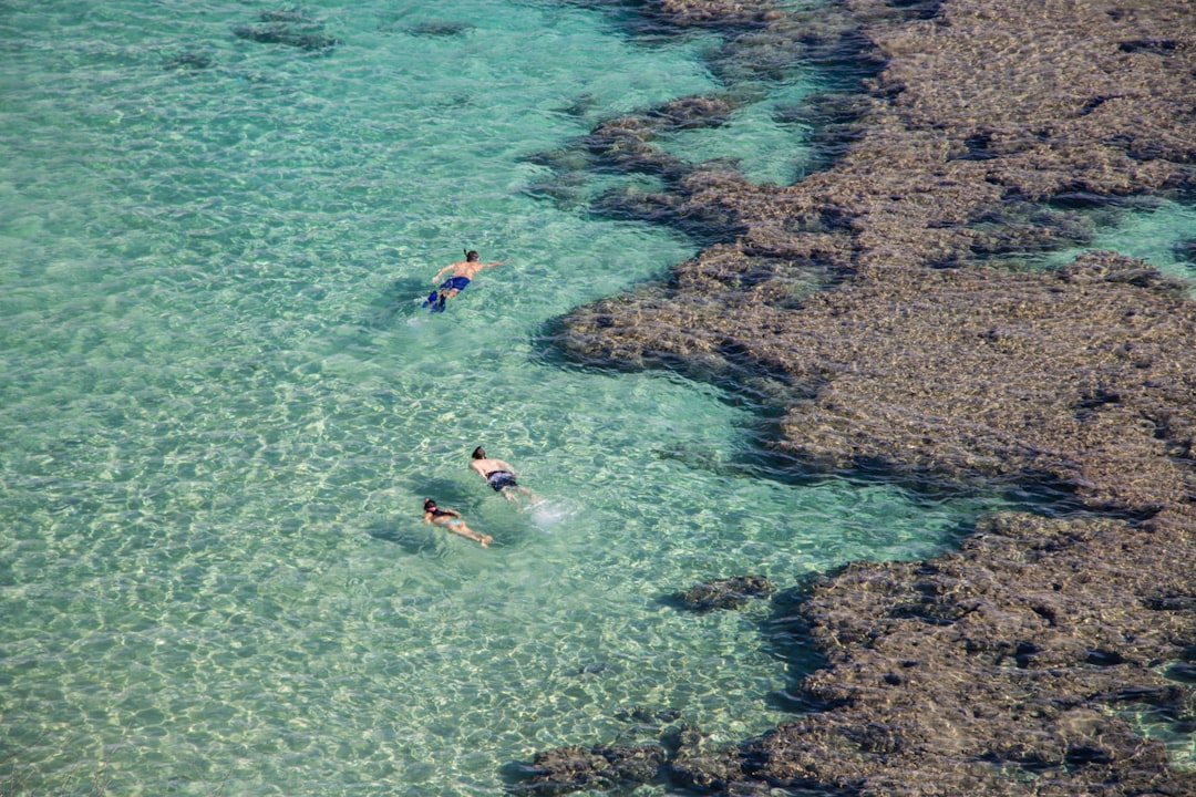 A couple snorkelling in turquoise water during one of the most popular island escapes reachable from Singapore in late August