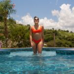 A woman preparing to enter a cold plunge pool as part of a contrast therapy session at a Singapore bathhouse