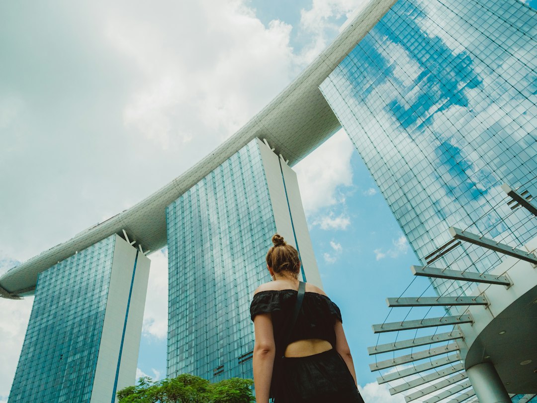 A businesswoman reviews data on a screen at a Singapore carbon credit exchange office, tracking market activity