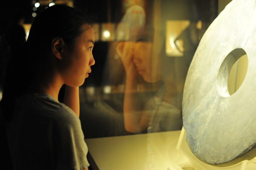 A young child digging in the Dino Pit at one of Singapore's best children's museums, smiling with excitement at a discovery.