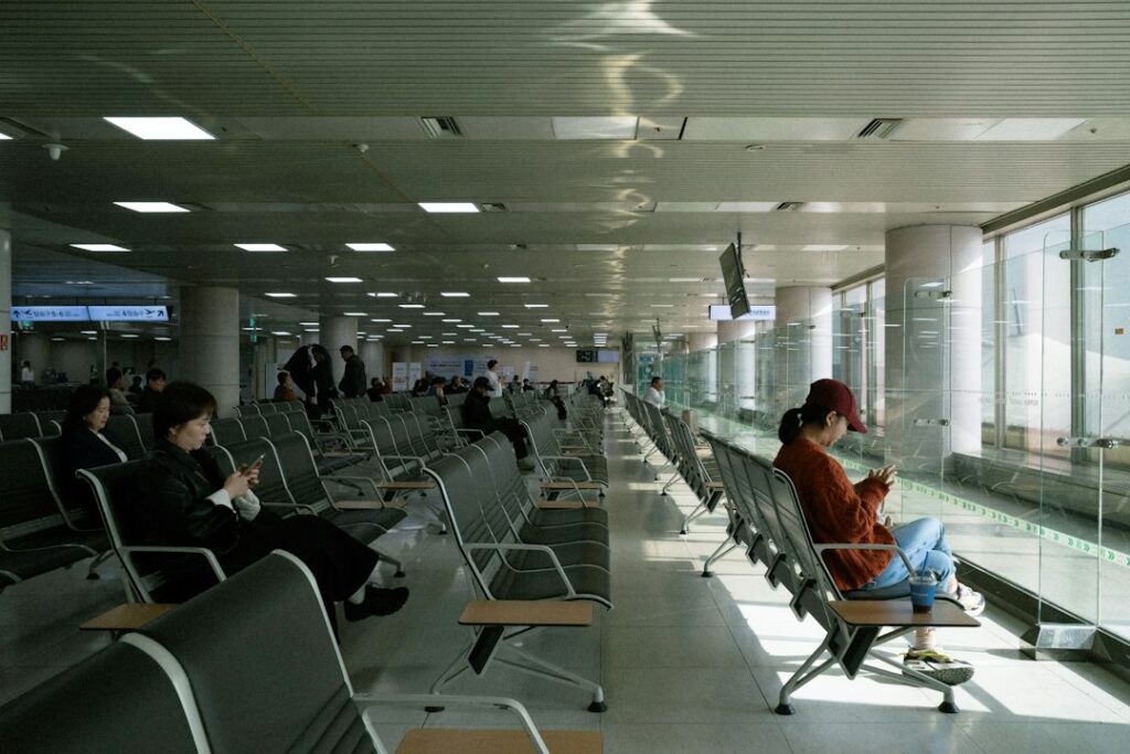 Traveler comparing year-end flights deals on a phone at Changi Airport